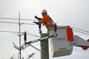 Woman utility worker on cherry picker