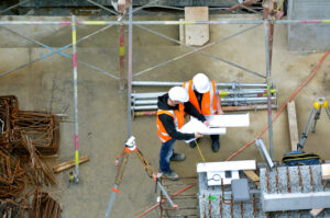 Men working on a construction site doing job hazard analysis.