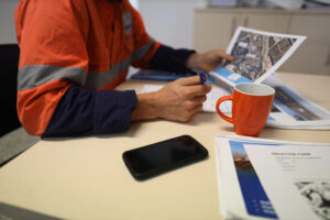 A man in a safety vest doing work hazard analysis.