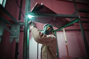 A guy welding.