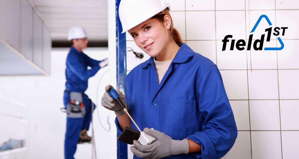 Female electrician in blue suit conducting hazard reporting.