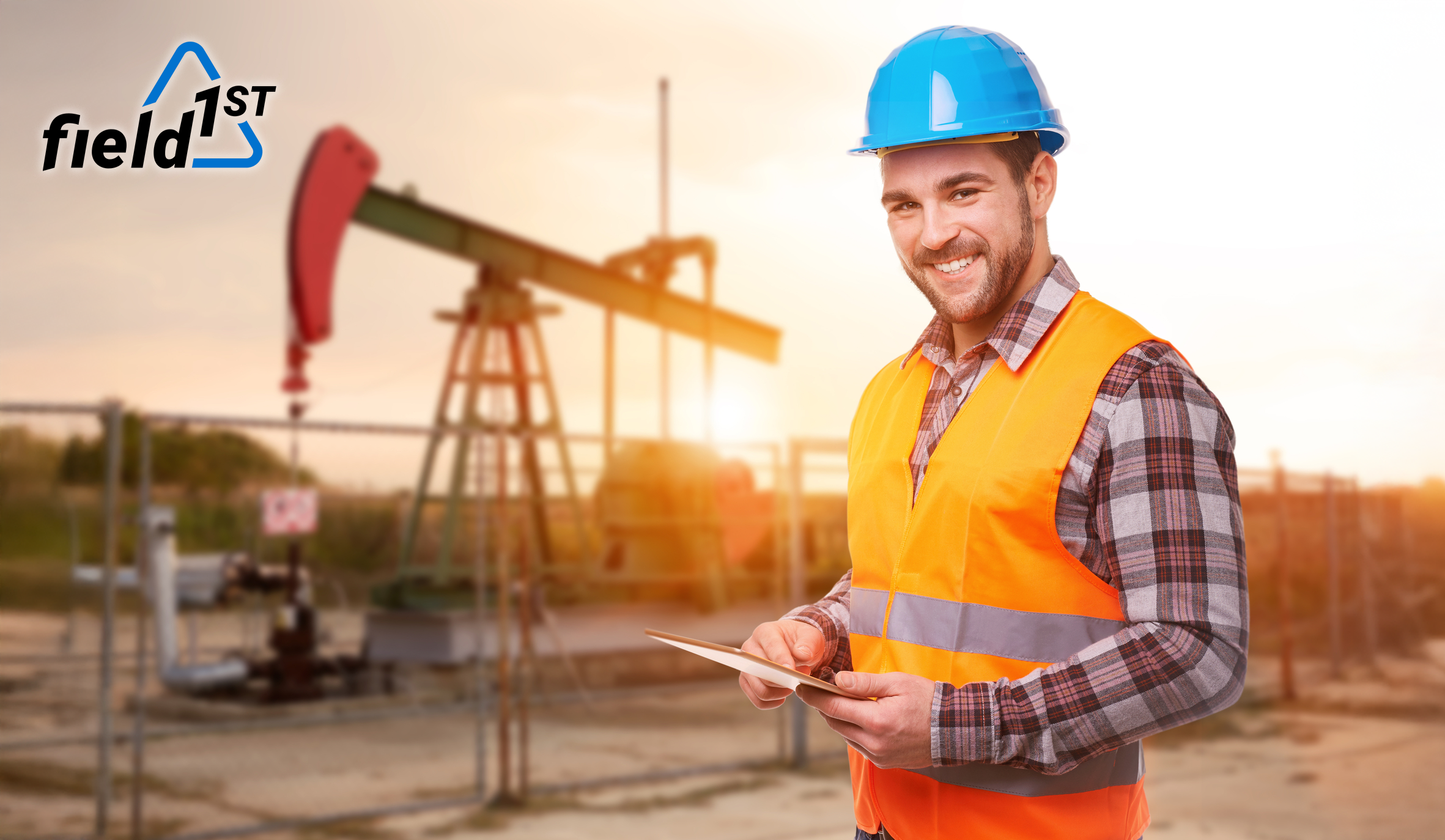 Man in front of dangerous oil rig using job safety evaluation tools on his tablet device.